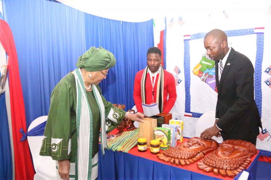 President Sirleaf views Made in Liberia Products at a Trade fair in Nairobi as Dep. Commerce Minister - Steve Marvie looks on